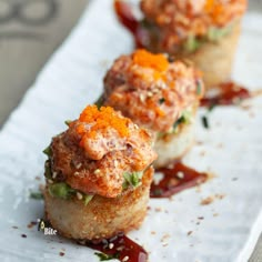 three small appetizers are sitting on a paper towel