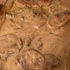 a casserole dish with meat and gravy on it, ready to be eaten