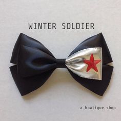 a black bow with a red star on it and the words winter soldier written in white