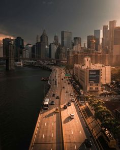 an aerial view of the city skyline with cars driving on it's highway and overpass