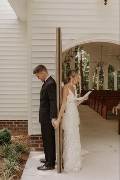 a bride and groom standing in front of the alter at their wedding ceremony, reading vows