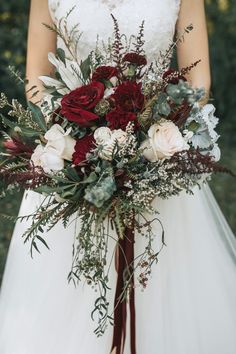 a bridal holding a red and white bouquet