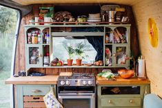 the inside of a small kitchen with an oven and counter space in front of it