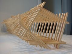 several pieces of wood stacked on top of each other in order to form a structure