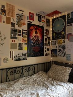 a bedroom with posters on the wall and a bed