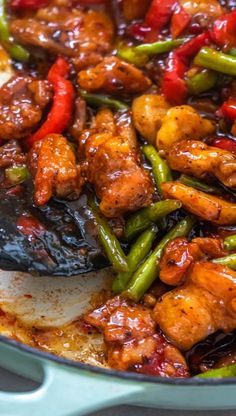 chicken and vegetables are being cooked in a skillet