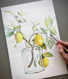 a woman is painting a lemon tree in a glass jar with watercolor pencils