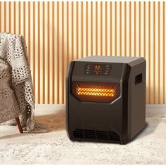 a black heater sitting on top of a counter next to a blanket