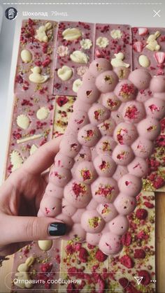 a person is holding up a piece of food with sprinkles on it