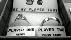 two wedding rings in a box that says,'be my player too? '