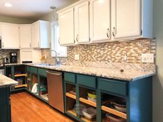 a kitchen with wooden floors and white cabinets