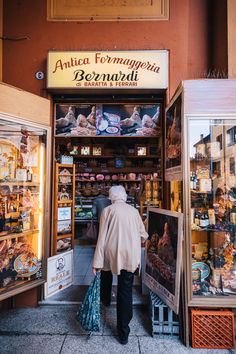 an old man is looking at items in the store