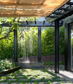 an outdoor shower in the middle of a garden