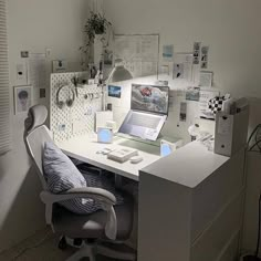 a white desk topped with a laptop computer