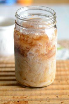 a jar filled with food sitting on top of a bamboo mat