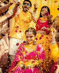 the bride and groom are throwing confetti on each other