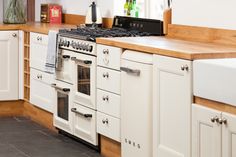 a kitchen with white cabinets and an oven