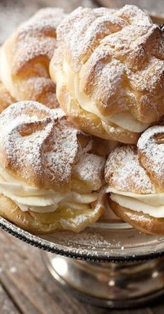 powdered sugar covered pastries on a glass plate