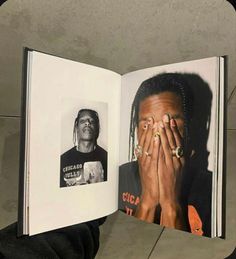 a person holding an open book in their hand with pictures on the inside of it