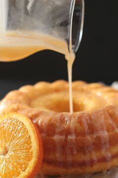 an orange slice being poured into a glazed donut