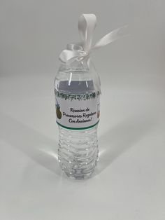 a bottle of water with a white ribbon around it