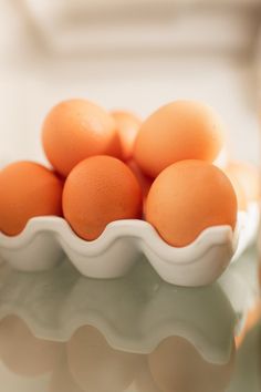 a white bowl filled with eggs on top of a table