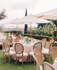 the table is set up with umbrellas and chairs