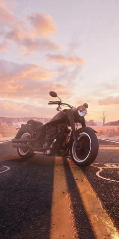 a motorcycle is parked on the side of the road in front of an orange sunset