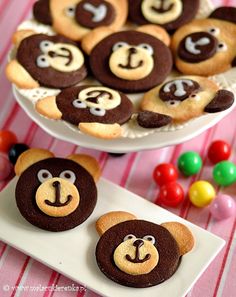 cookies decorated with monkey faces are on plates