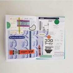 an open passport book with stamps and stickers on it