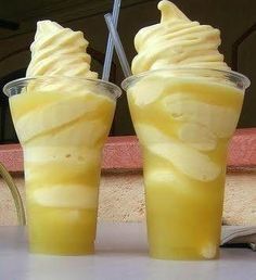 two glasses filled with ice cream sitting next to each other