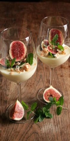 two wine glasses filled with dessert and fruit