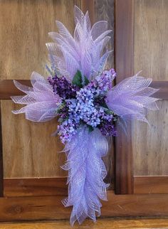 a bouquet of purple flowers sitting on top of a wooden door