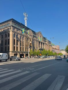 an old building on the corner of a street with cars parked in front of it