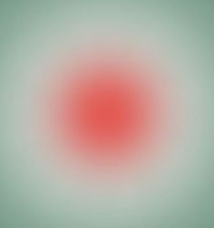 an abstract red and green background with a circular design in the center, which appears to be blurry