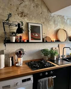 a kitchen with a stove top oven sitting next to a wall filled with pots and pans