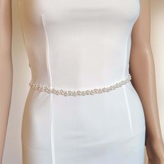 "This bridal belt is made entirely by hand with a multitude of pearl beads. A very elegant accessory that will add the perfect accent to any bridal or bridesmaid's dress. Wired on copper wire, it is very flexible and will easily fit around your waist.  The belt can be laced on the back with double-sided satin ribbon.   original Happy Wedding Dreams model handmade in my workshop in France (Meuse) * flexible for a perfect fit * modifiable and customizable according to stock availability * production time 3-5 working days DIMENSIONS:  decorative part: length 40 cm (15.7\") or 60 cm (23.6\");  width 1.2 cm (0.47\")   satin ribbon: width 0.6 cm (1/4\") total length: 200 cm (78.7\") *Due to the entirely manual process, dimensions may vary slightly - 1 cm)!  COLOUR OPTION: This accessory comes wi Belt Wedding Dress, Bridal Sash Belt, Wedding Dress Belt, Wedding Sash Belt, Bridal Hair Clip, Bridal Sash, Wedding Belts, Pearl Bridal, Sash Belts