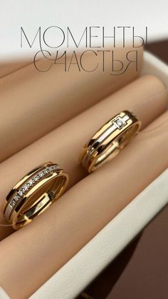 two gold wedding rings sitting on top of each other in a ring box with the words, mom and daughter written across them