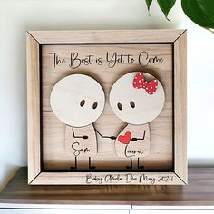 a wooden frame with two people holding hands