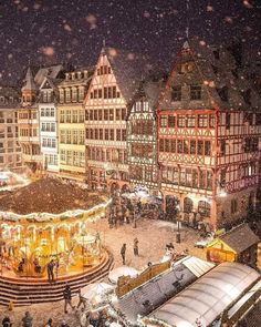 an aerial view of a christmas market in the snow