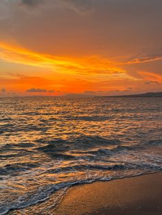 the sun is setting over the water at the beach