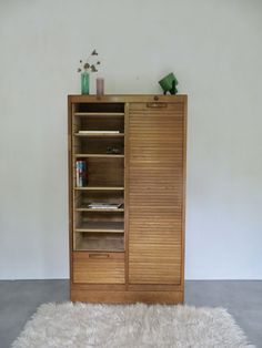 a wooden cabinet sitting on top of a white rug