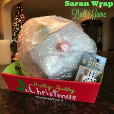 a ball of plastic wrap sitting in a christmas gift box