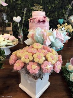 a table topped with lots of cakes and desserts