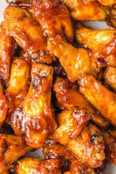 chicken wings covered in bbq sauce on a white plate