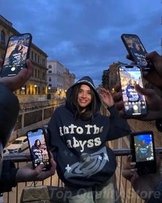 a group of people holding up their cell phones