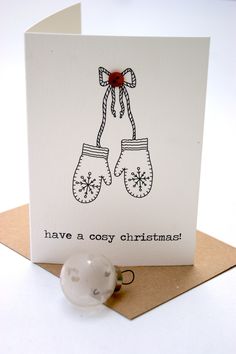 a christmas card with two mittens on it