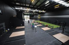 an indoor gym with rows of exercise mats and benches for people to sit down on