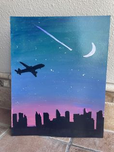 a painting of an airplane flying in the night sky over a cityscape and moon