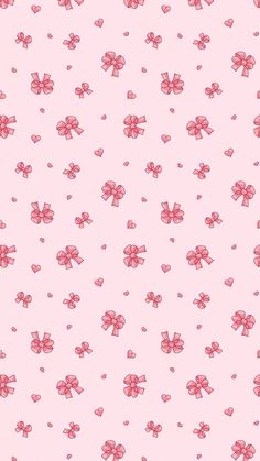 a pink wallpaper with hearts and bows on it